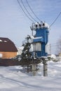 Snow-covered rural transformer substation on edge of village Royalty Free Stock Photo