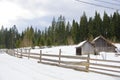 Snow covered rustic cabins in the woods in winter. Royalty Free Stock Photo