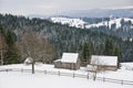 Snow covered rustic cabins in the woods in winter. Royalty Free Stock Photo