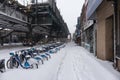 Snow Covered Sidewalk with Stores Near Elevated Subway Tracks in Astoria Queens New York during Winter Royalty Free Stock Photo