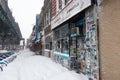 Snow Covered Sidewalk with Stores Near Elevated Subway Tracks in Astoria Queens New York during Winter Royalty Free Stock Photo