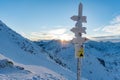 Snow covered sign marking trails on the Zawrat Pass in the winter Tatra Mountains. Royalty Free Stock Photo