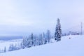 Snow-covered ski slope in the mountains with a lift and skiers skating away Royalty Free Stock Photo