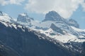 Snow covered slopes of the Alps in the spring in Region of Engelberg canton Obwalden in Switzerland with white clouds on the backg