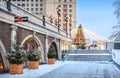 Snow-covered staircase and New Year tree