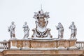 Snow-covered statues on the roof of St. Peter`s Cathedral in Vatican City in Rome in Italy