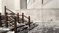 Snow-covered steps of the temple. Wooden staircase in winter. Snowy winter. The steps of the white-stone church, cleared of snow Royalty Free Stock Photo