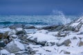 Snow-Covered Stones on the Ocean Coastline