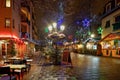 Snow-covered street cafe tables on winter street, Strasbourg, Ch