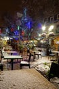 Snow-covered street cafe tables on winter street, Strasbourg, Ch