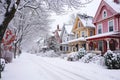 A snow-covered street lined with houses and trees creates a winter scene, Victorian houses lined up on a snow-laden street, AI Royalty Free Stock Photo