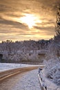 Snow covered street in sunrise in winter