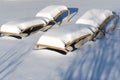 Snow covered sunbeds on sunny day in winter Royalty Free Stock Photo