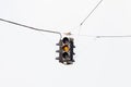 A Snow Covered Suspended Amber Traffic Light