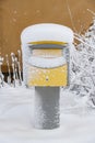 Snow covered Swedish yellow letterbox