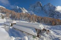 Snow-covered tables facing awesome Mount Pelmo winter panorama