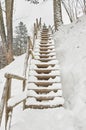 Snow-covered tourist stairs woods