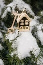 On a snow-covered tree branch a golden decorative house and key to the castle, Christmas decorations, the concept Royalty Free Stock Photo