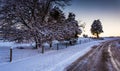 Snow covered trees and field along a dirt road in rural York County, Pennsylvania. Royalty Free Stock Photo