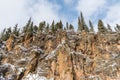 Snow-covered trees and stormy sky atop colorful cliffs in New Mexico Royalty Free Stock Photo