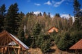 Snow covered trees in winter forest with wooden house. Royalty Free Stock Photo