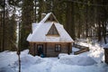 Snow covered trees in winter forest with wooden house. Royalty Free Stock Photo