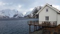 White Rorbu cottage and Reinefjorden from Toppoy island on the Lofoten in Norway in winter