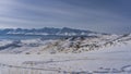 In the snow-covered valley, trampled paths and footprints are visible Royalty Free Stock Photo