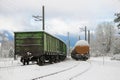 Snow-covered vintage trains in a snowy landscape.