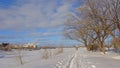 Snow covered walking pathway along Ottawa river, with industrial buildings of Hull district, Gatineau on the other side