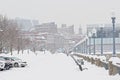 Snow covered walkway along Lachne canal in the old port of Montreal, with skyscrapers in the distance