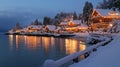 Snow covered waterfront homes illuminated at night Royalty Free Stock Photo