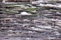 Snow-covered wattle fence from wooden branches Royalty Free Stock Photo