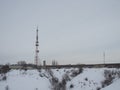 Snow-covered winding road leads to the radio tower with cellular phone in winter, near the village in the north of the Arctic Royalty Free Stock Photo