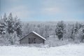 Snow covered winter landscape with old wooden shed