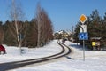 Snow-covered winter road in a no name village and a lone traveler