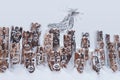 Snow-covered wooden art object in the Perm Krai, Russia - group of idols depicting anthropomorphic figures and elk