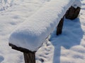 Snow covered a wooden bench Royalty Free Stock Photo