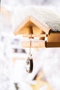 Snow covered wooden birdfeeder in winter Royalty Free Stock Photo