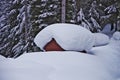 Snow covered wooden cabin