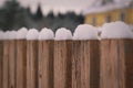 Snow is lying on an old wooden fence, close up Royalty Free Stock Photo