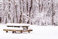 A snow covered wooden picnic table in a field in Frick Park in Pittsburgh, Pennsylvania, USA Royalty Free Stock Photo