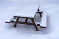 Snow covered wooden picnic table Royalty Free Stock Photo