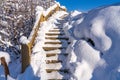 Snow covered wooden stairs in the mountains in winter Royalty Free Stock Photo