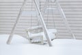 Snow covered wooden swing after heavy snow Royalty Free Stock Photo