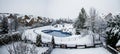 Snow-covered yard with a pool in a beautiful neighborhood in Bucharest. Christmas background.