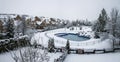 Snow-covered yard with a pool in a beautiful neighborhood in Bucharest. Christmas background.