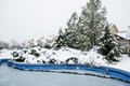 Snow-covered yard with a pool in a beautiful neighborhood in Bucharest. Christmas background.