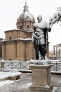 Snow covers the streets of Rome, Italy. Statue of Ciulio Cesare.