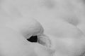 Snow cushions lie on the rocks on the bank of a mountain river